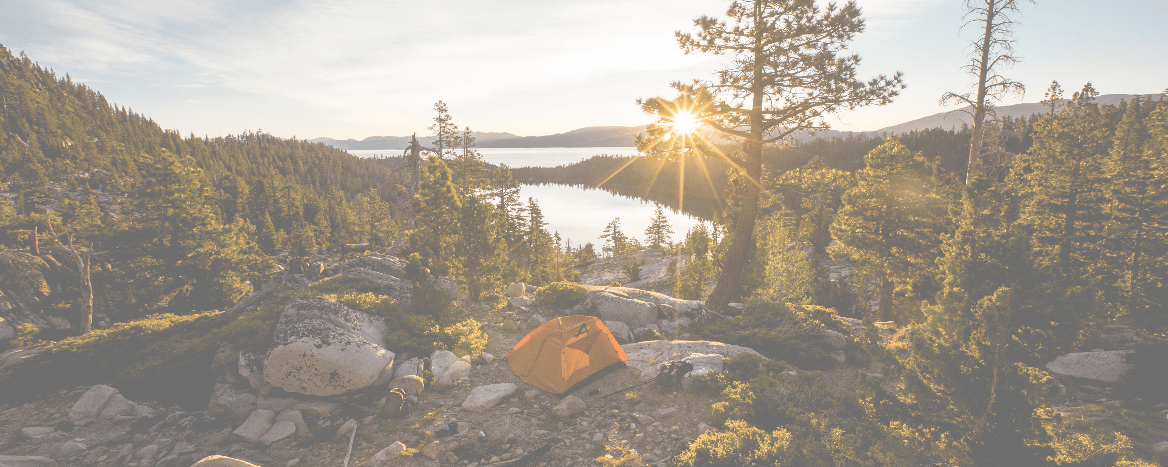 summer camping scene at sunrise on a mountain with an EverVenture camping toilet and EverVenture pop-up tent