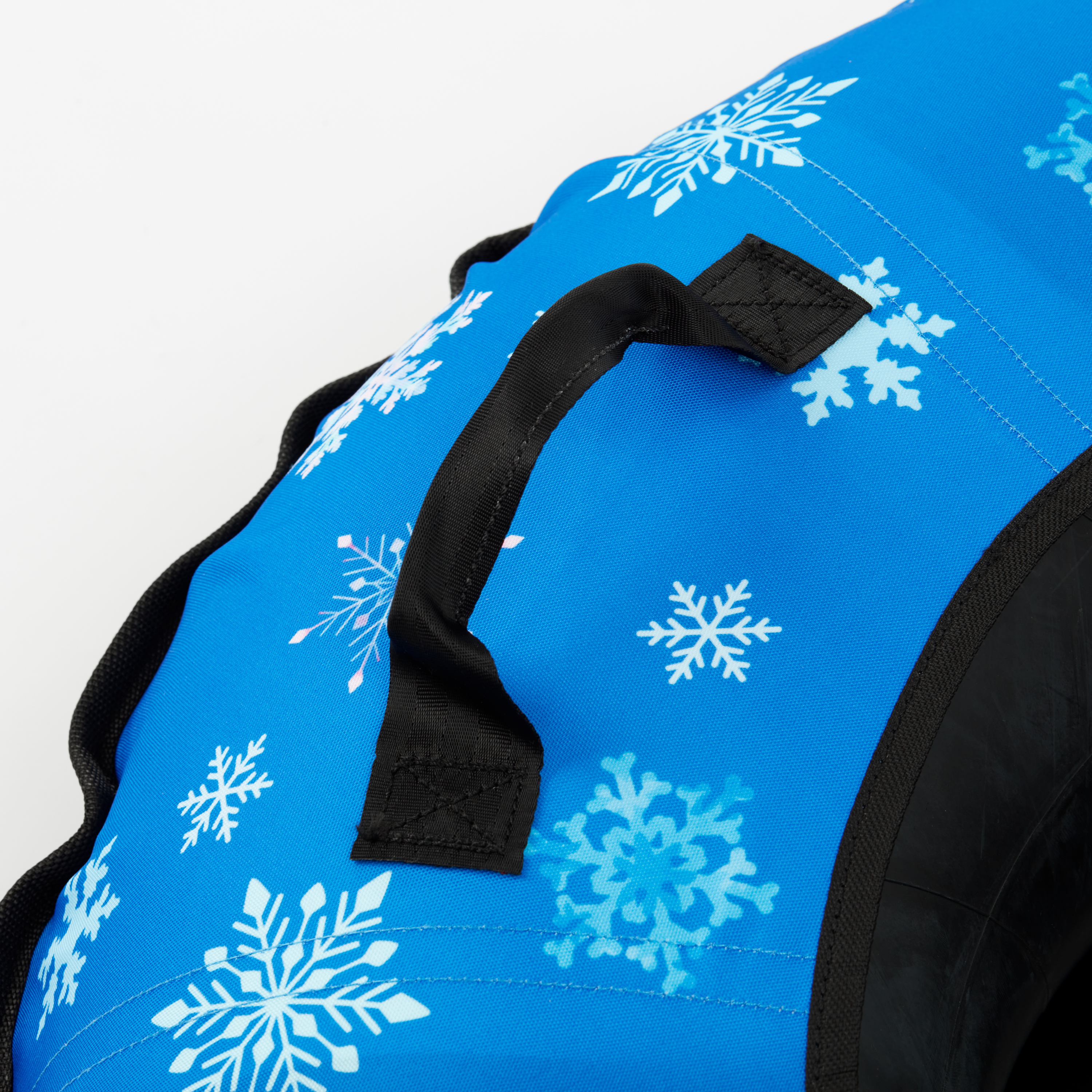 Blue bag with white snowflake patterns and black handles on a white background