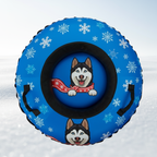 Blue snow tube with snowflake pattern and dog illustration on a snowy background