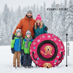 Family posing with a pink sled featuring cartoon dogs in the snow, branded 'Everventure'.