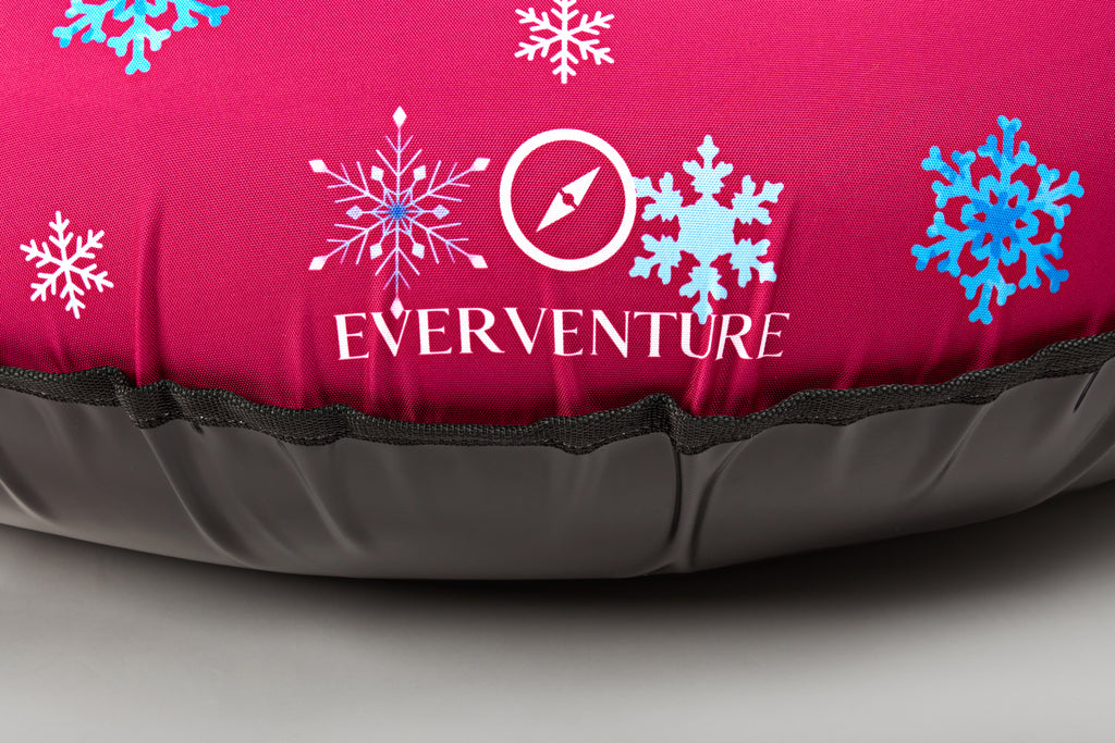 Inflatable sleeping pad with 'Everventure' logo and snowflake designs on a pink background